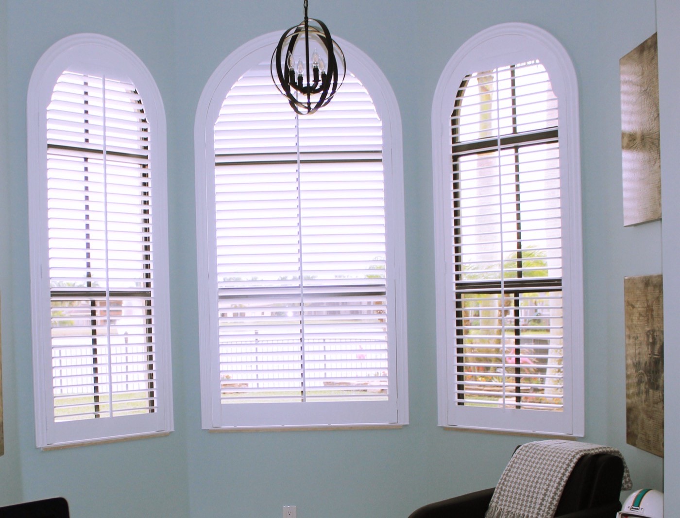 A room dressed with custom shutters and warm filtered light