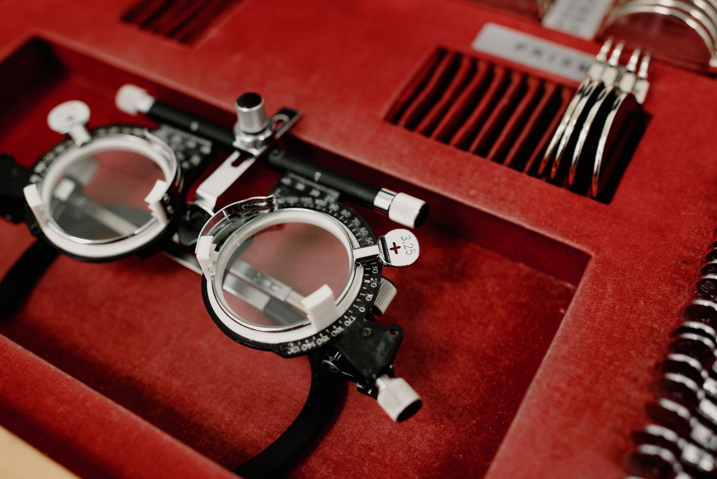 A trial fitting frame resting on red velvet