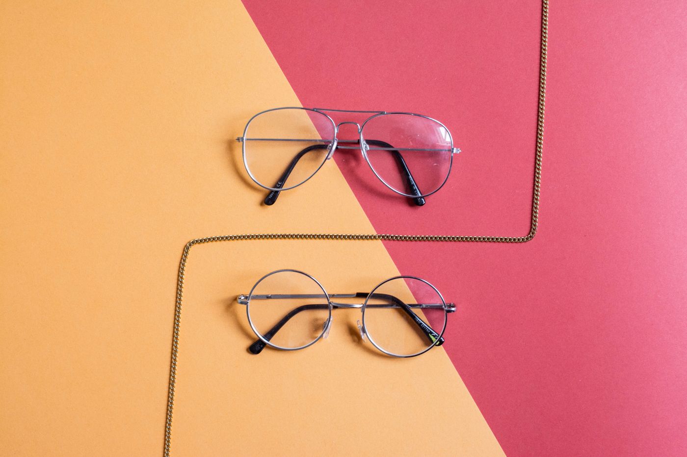 Prescription frames on a bold colour-block background