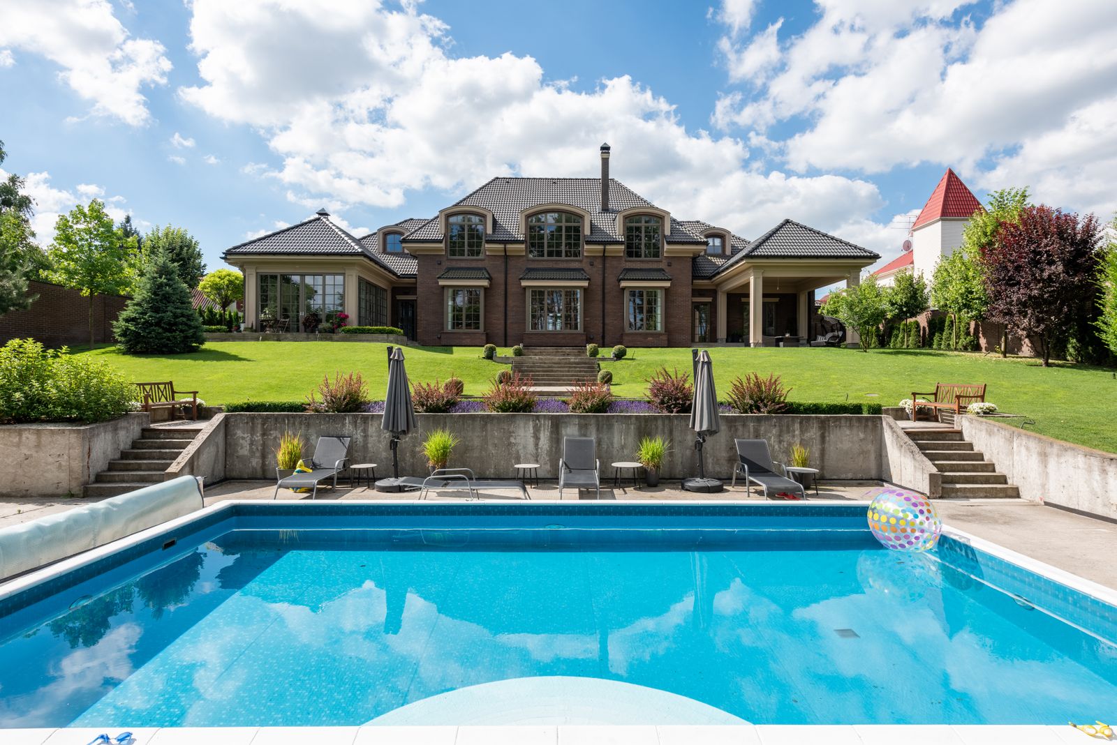 Estate backyard pool with loungers