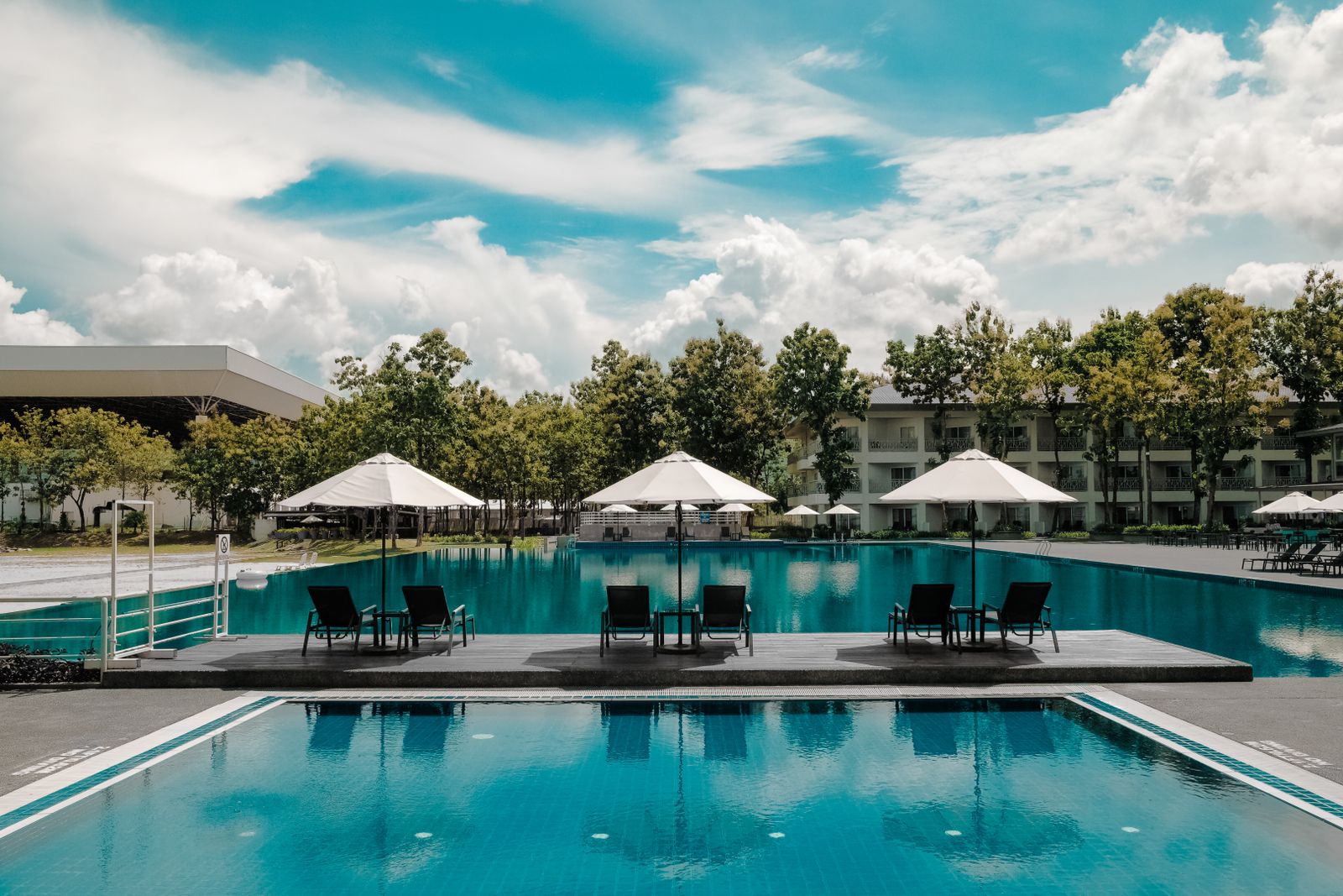 Filled resort-style pool with loungers