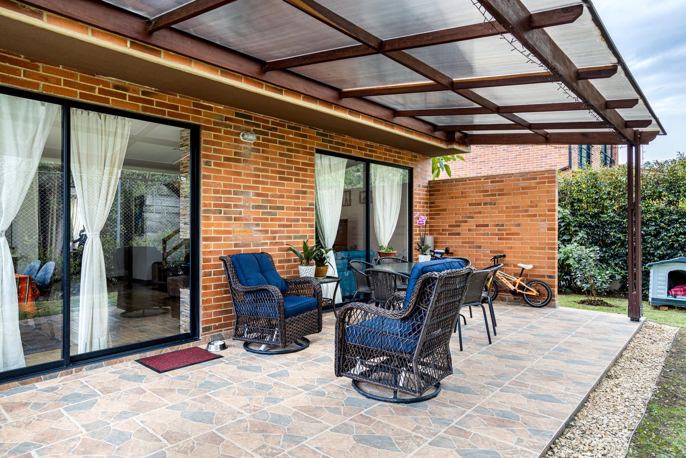 Patio cover over a paved patio at a brick home