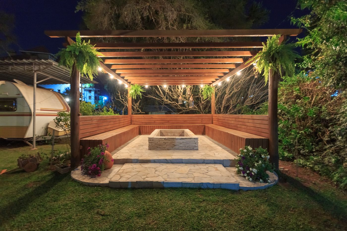 Lit pergola over a patio in the evening