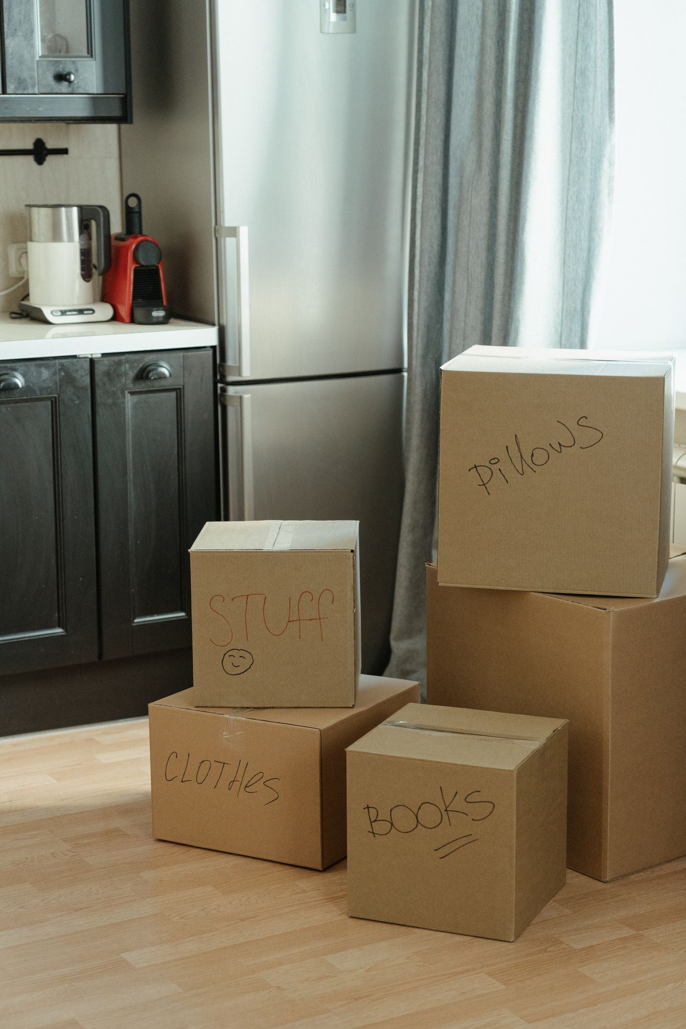 Boxes packed and set on a cabinet in a kitchen mid-move