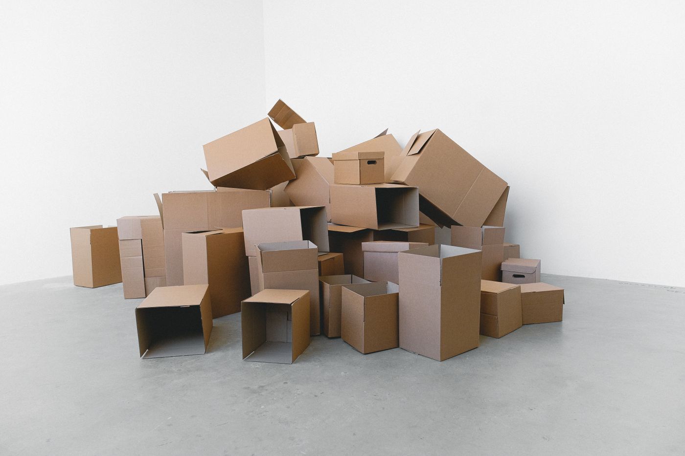 Cardboard moving boxes packed and stacked on the floor, ready to load