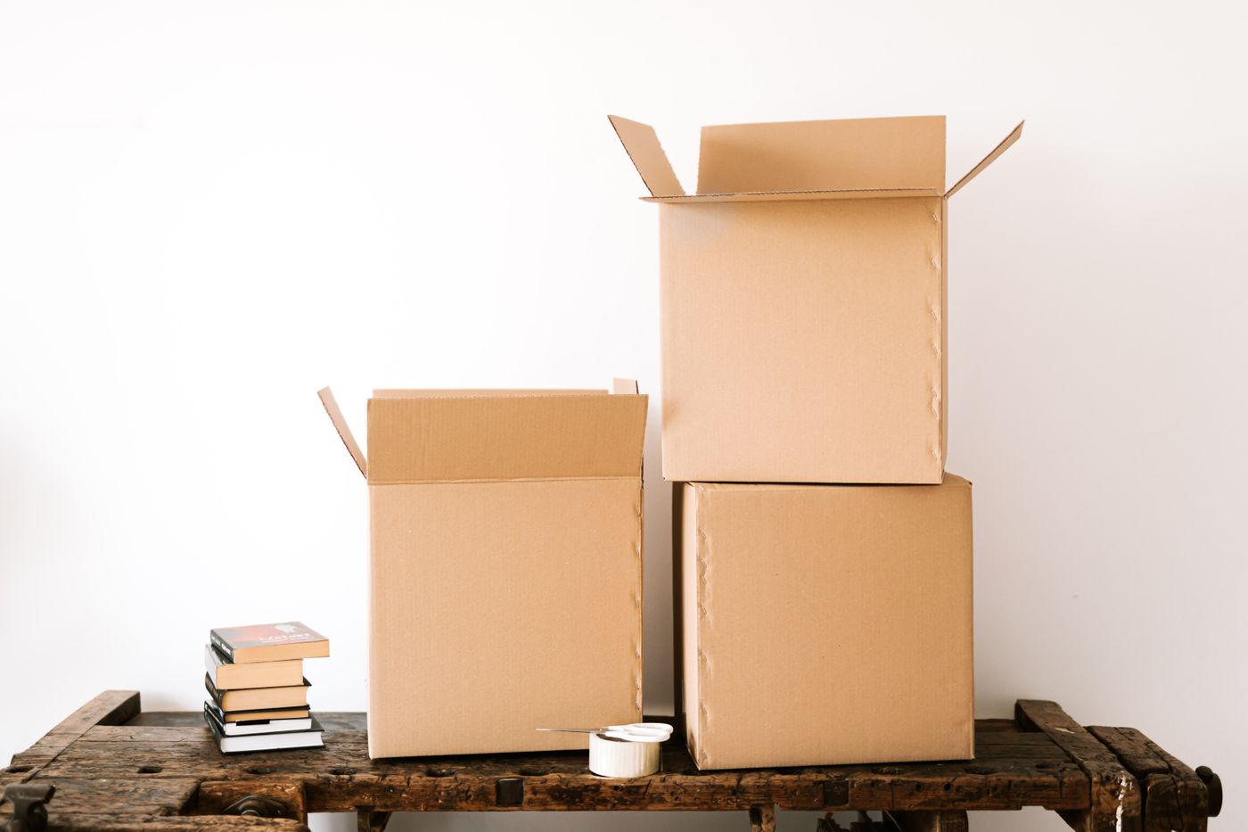 A box hand-labelled and packed with books on a table