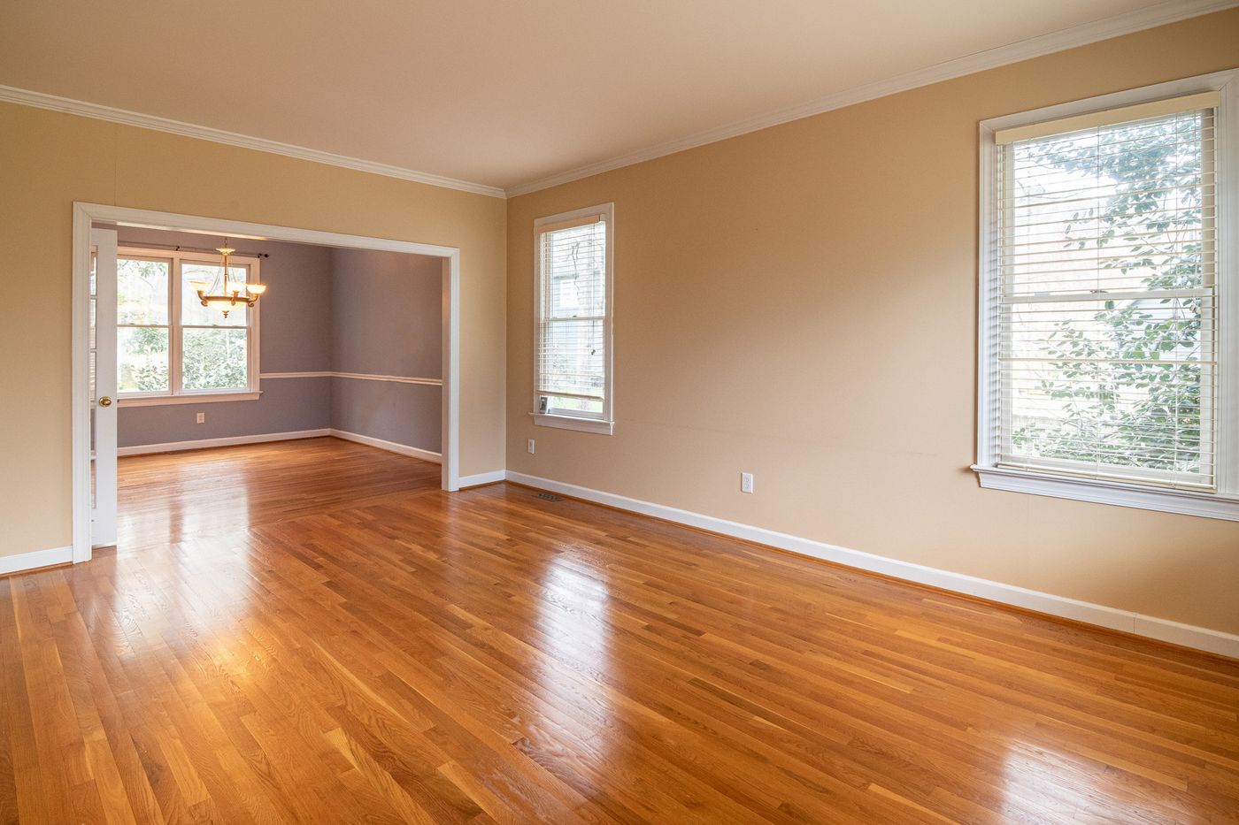 A bright empty room with wood floors after a careful move-out