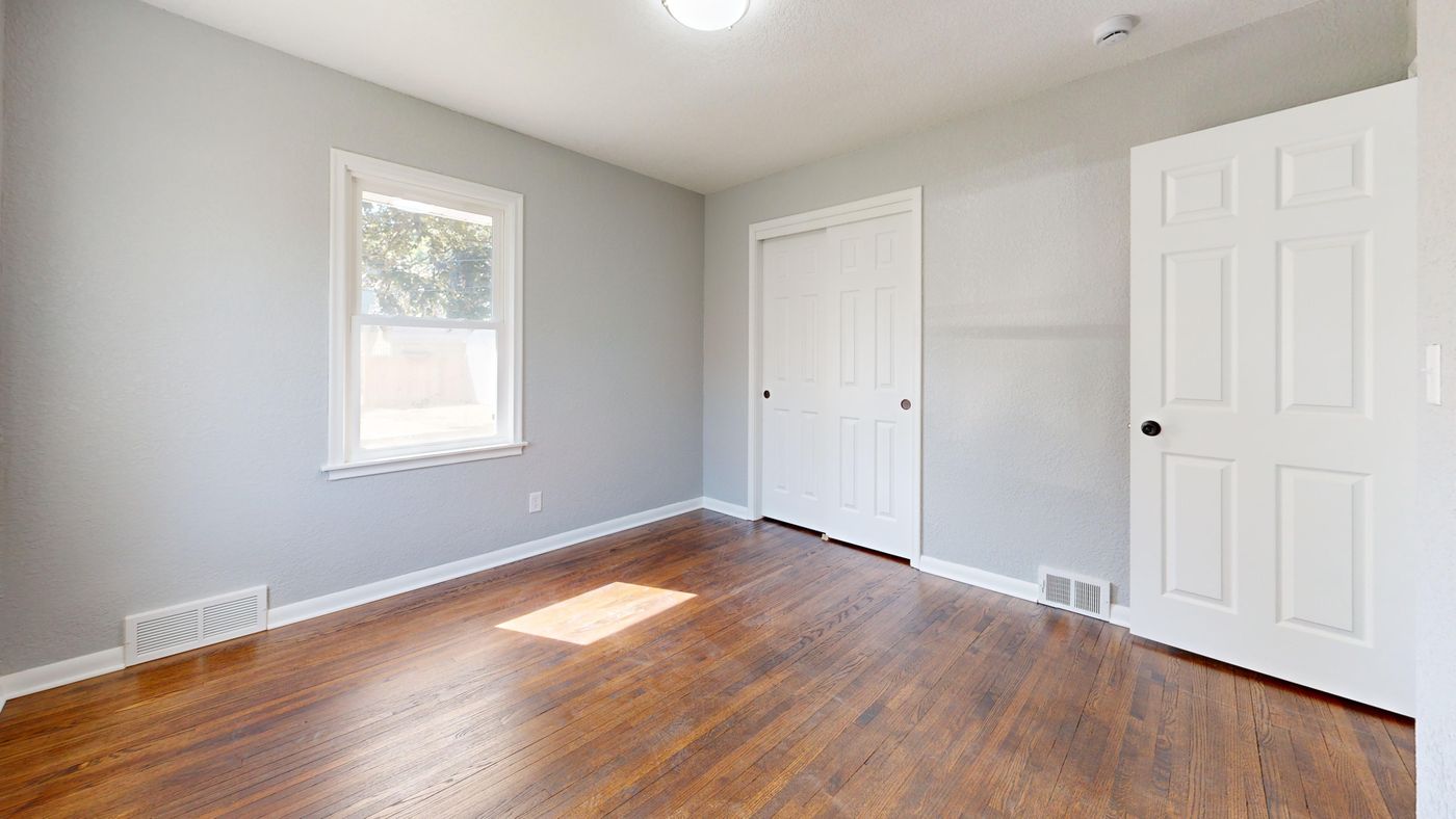 A bright empty room with a window, ready for the next family