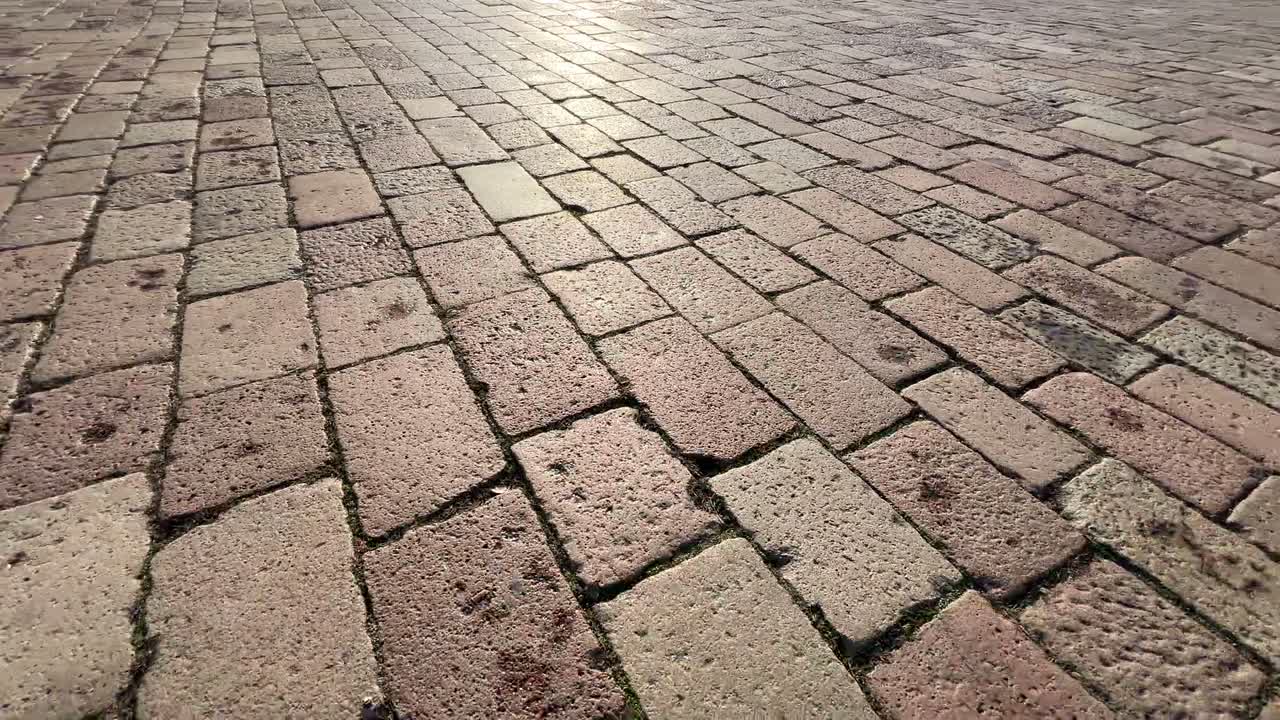 Sunlit natural stone wall and brickwork