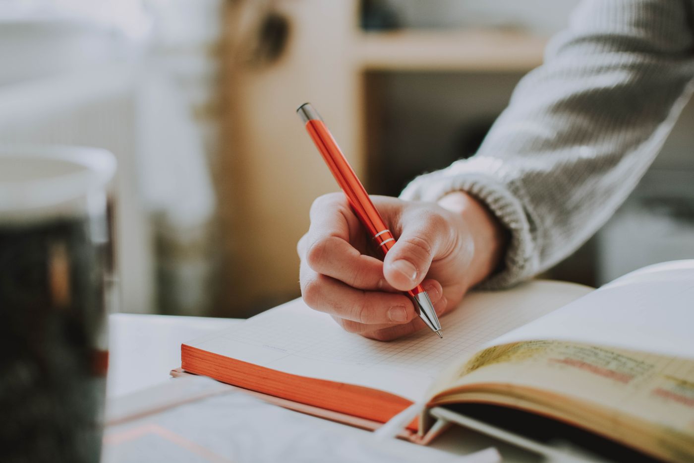 A hand writing with a pen