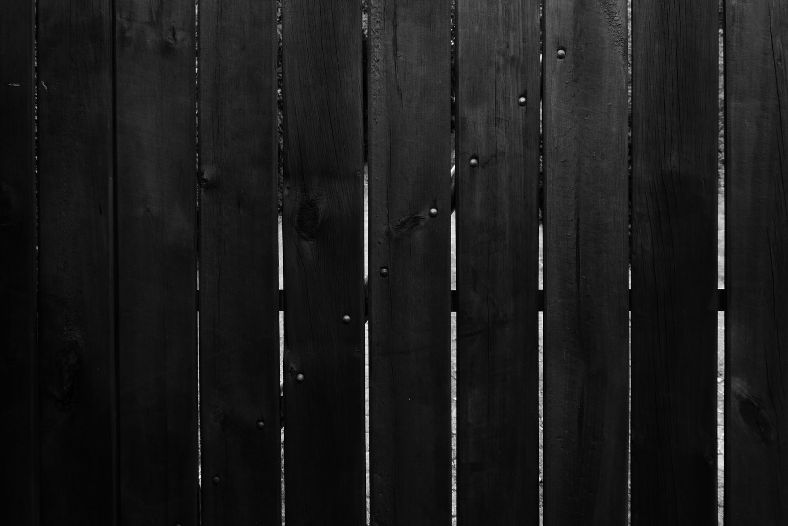 Dark cedar fence boards at dusk