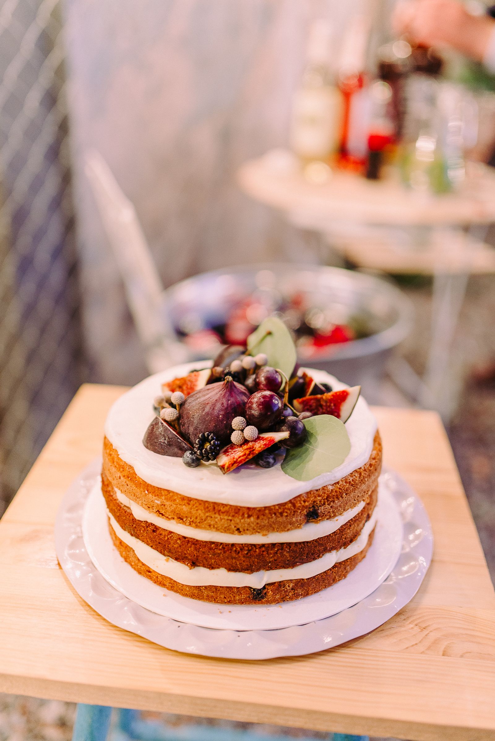 Naked layer cake topped with fresh berries