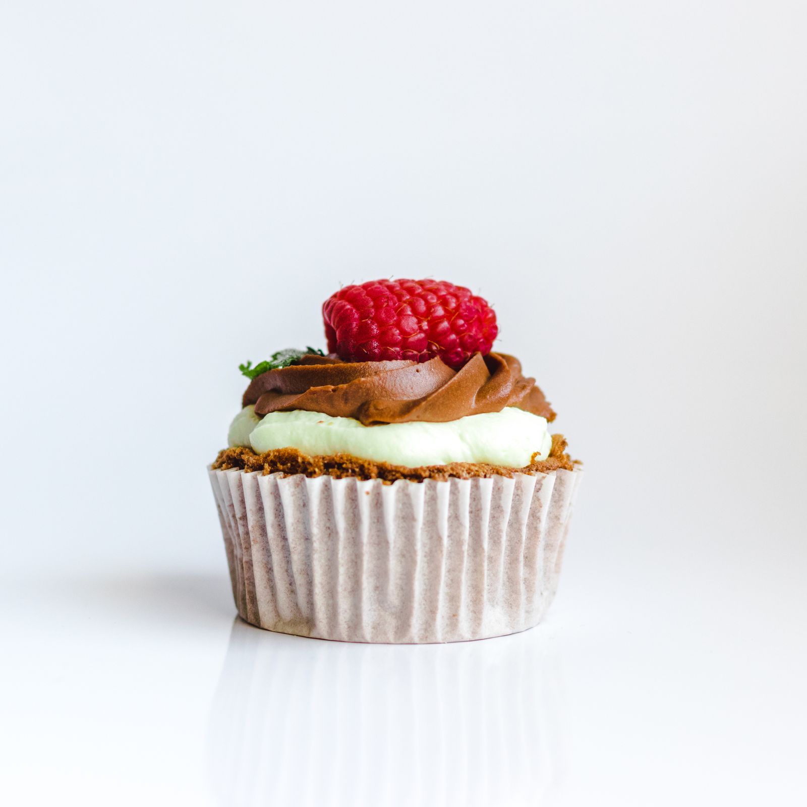 Buttercream cupcake with a raspberry on top