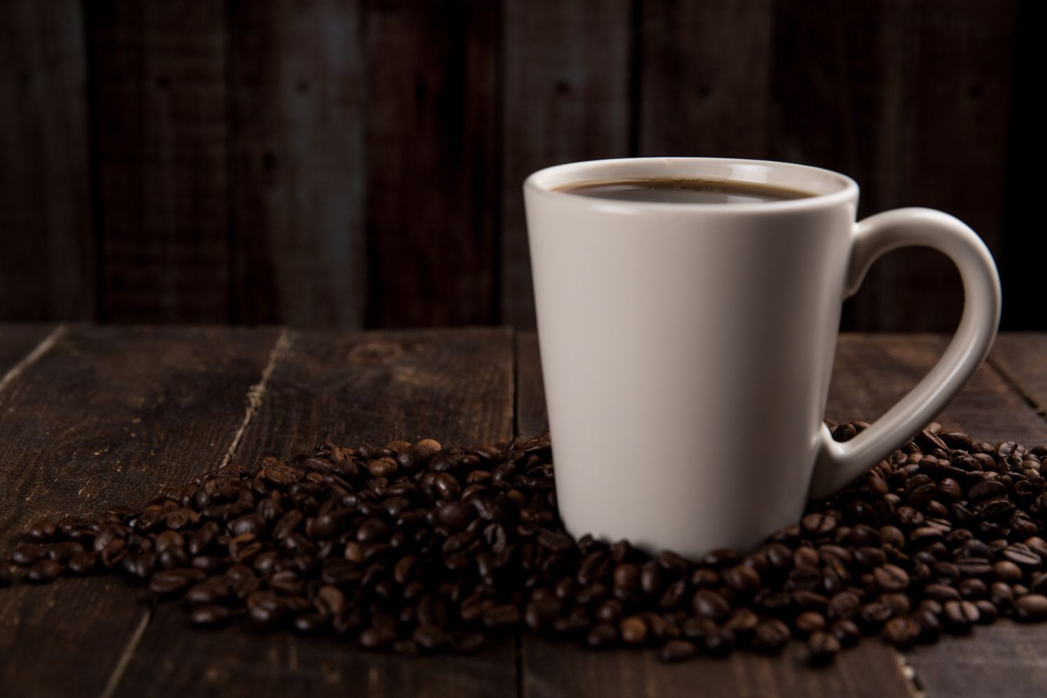 Cup of coffee on beans