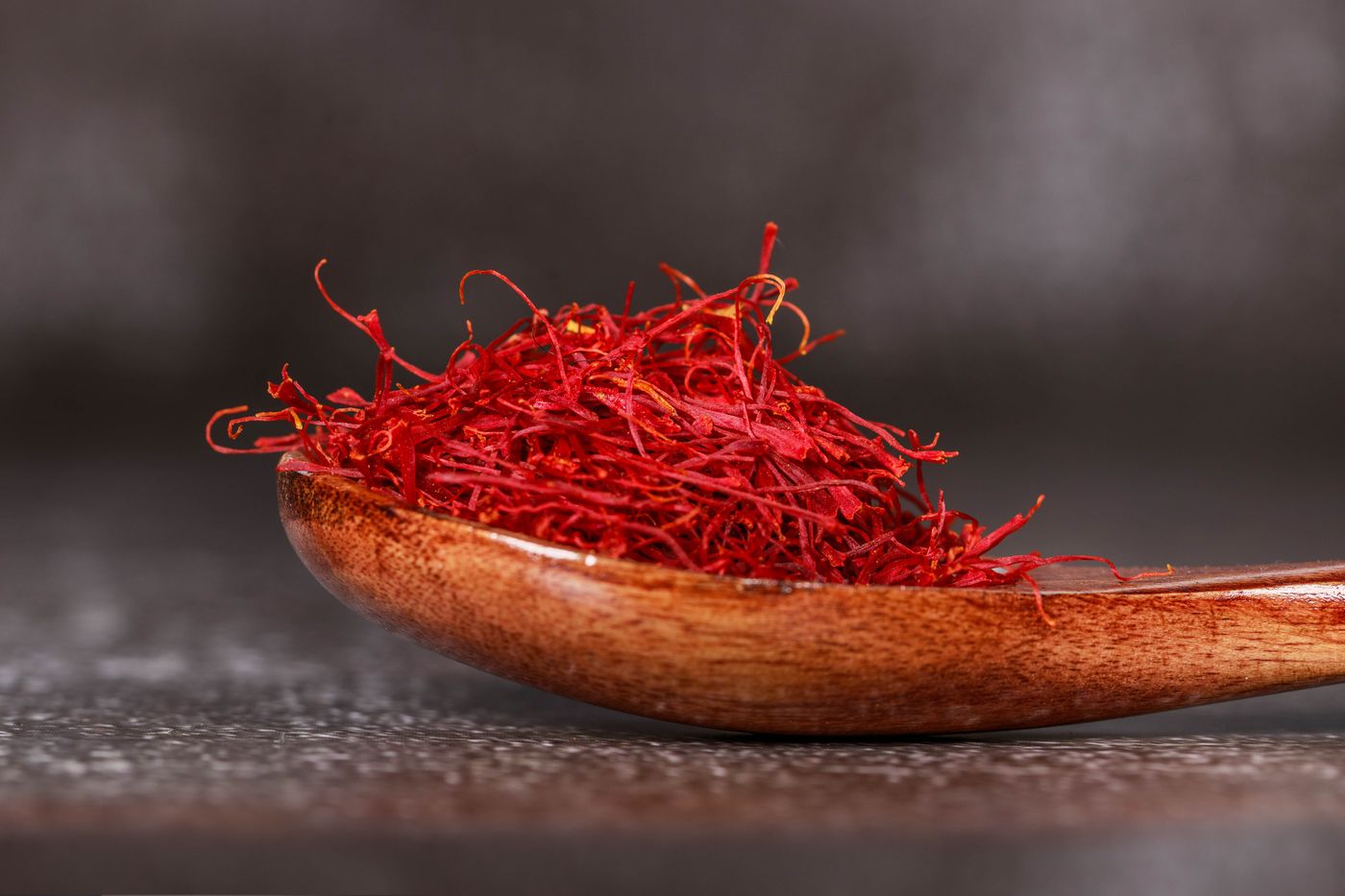 Saffron threads in a wooden spoon
