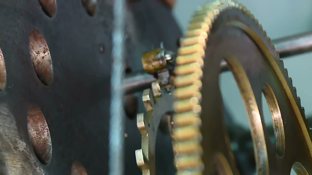 Brass clock movement gear turning on the bench