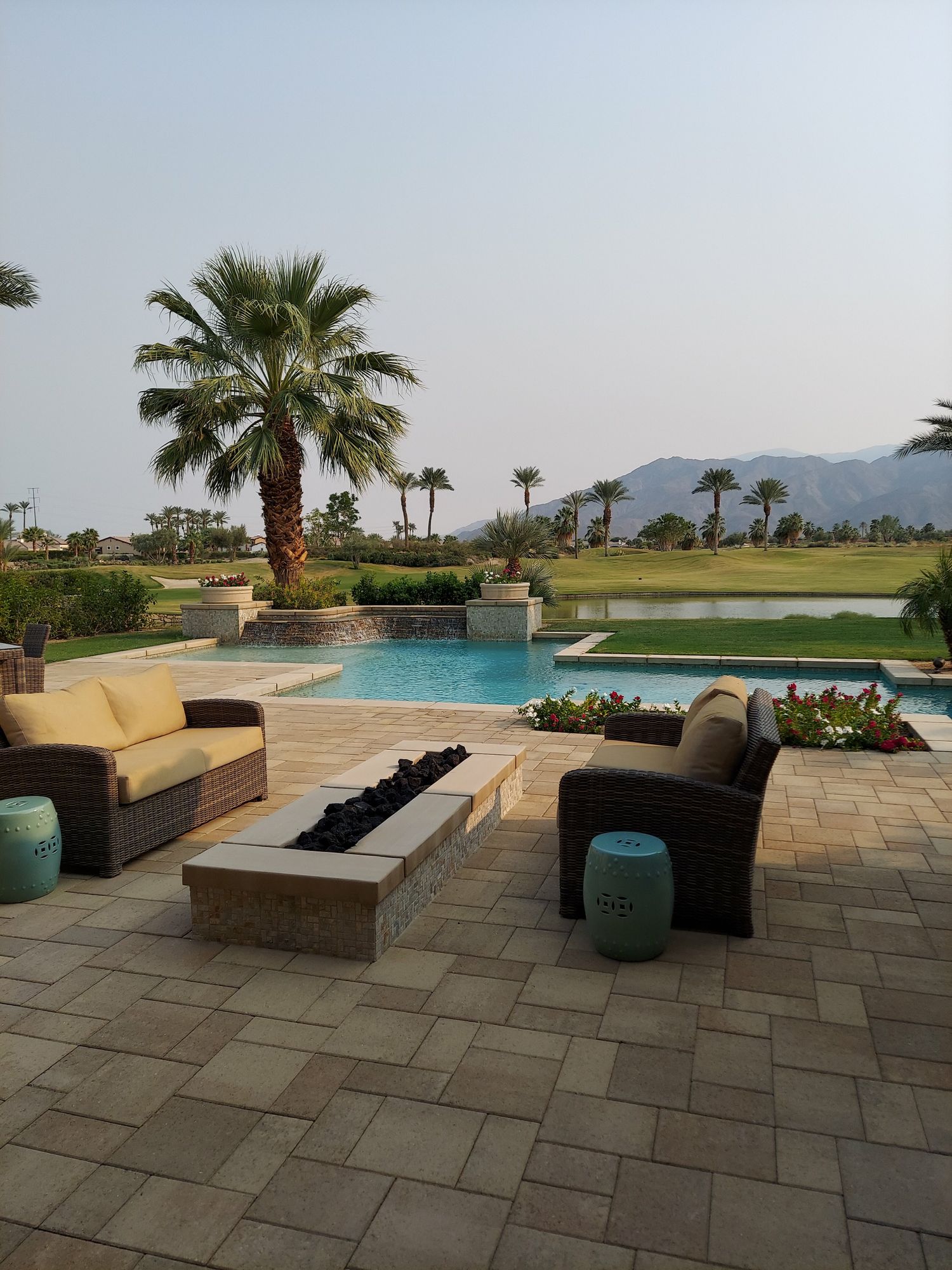 A paver patio beside a pool
