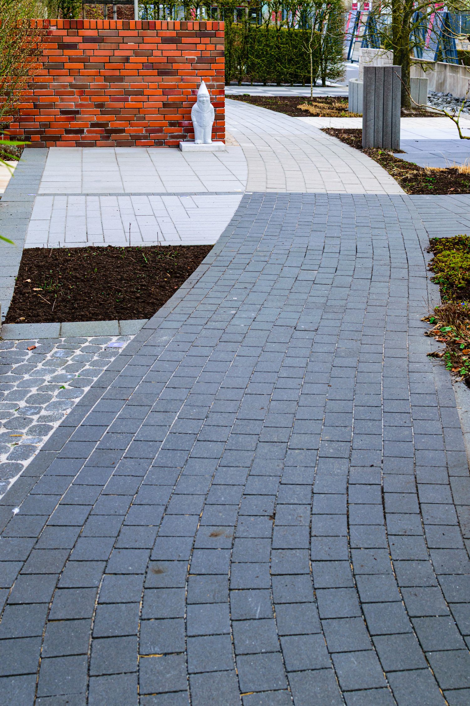 A curved paver path through a lawn