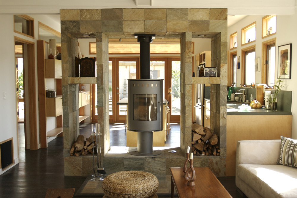 A freestanding gas stove in a stone surround