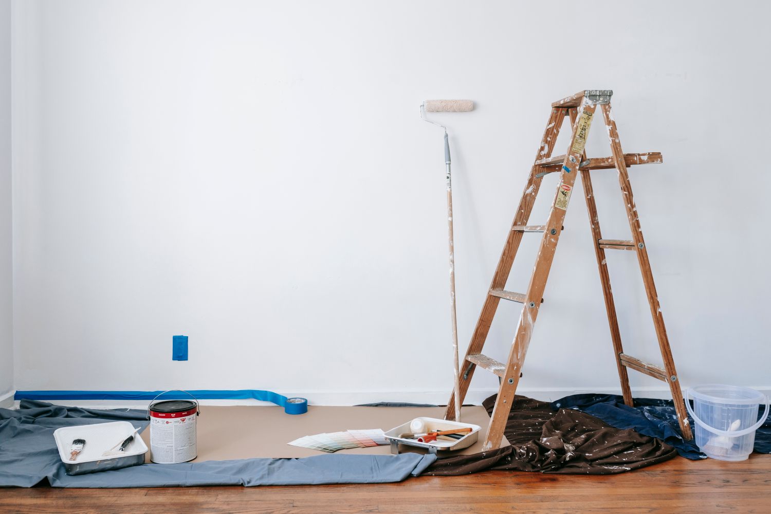 A bright room mid-job with a stepladder set up