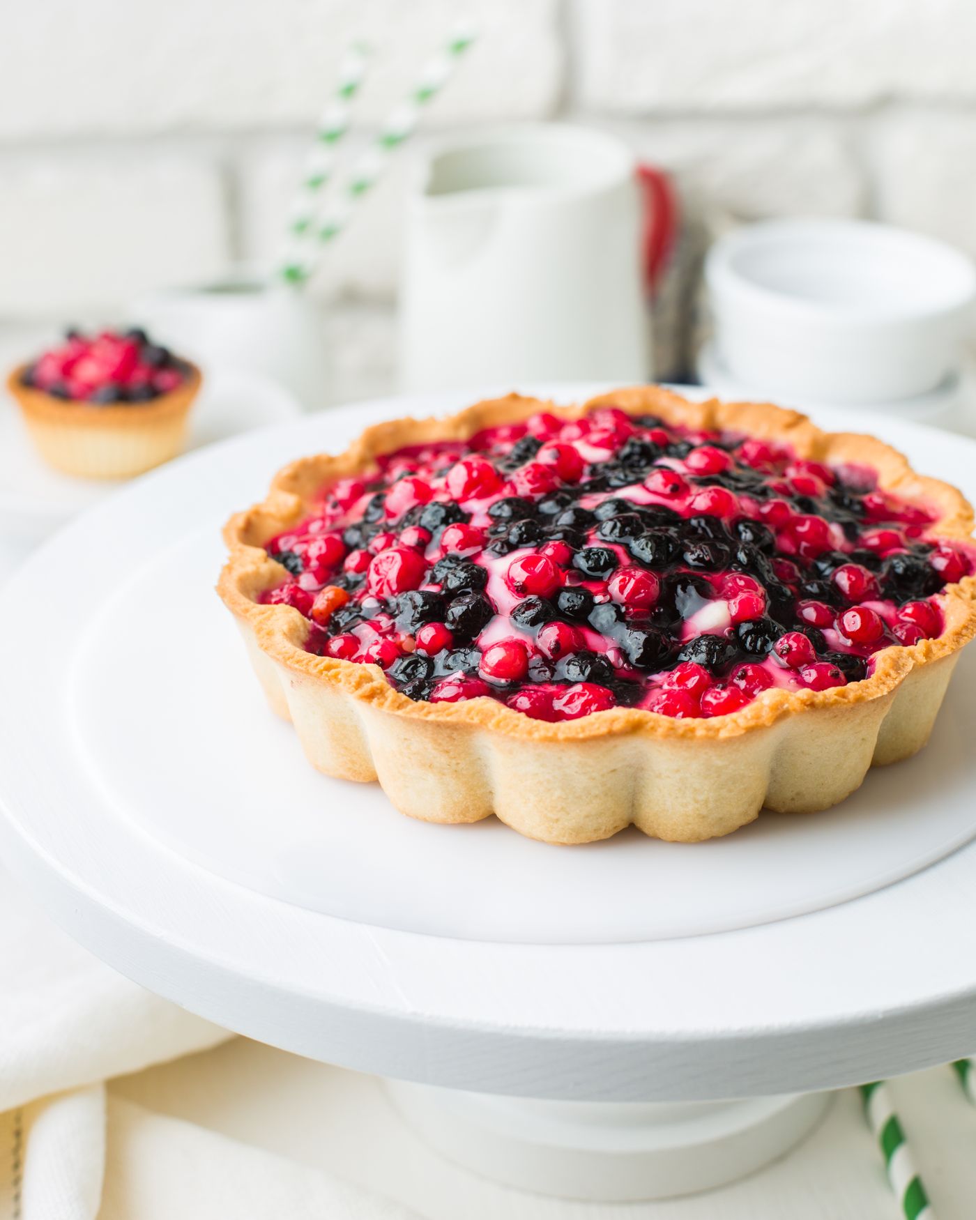 A mixed-berry tart on a cake stand