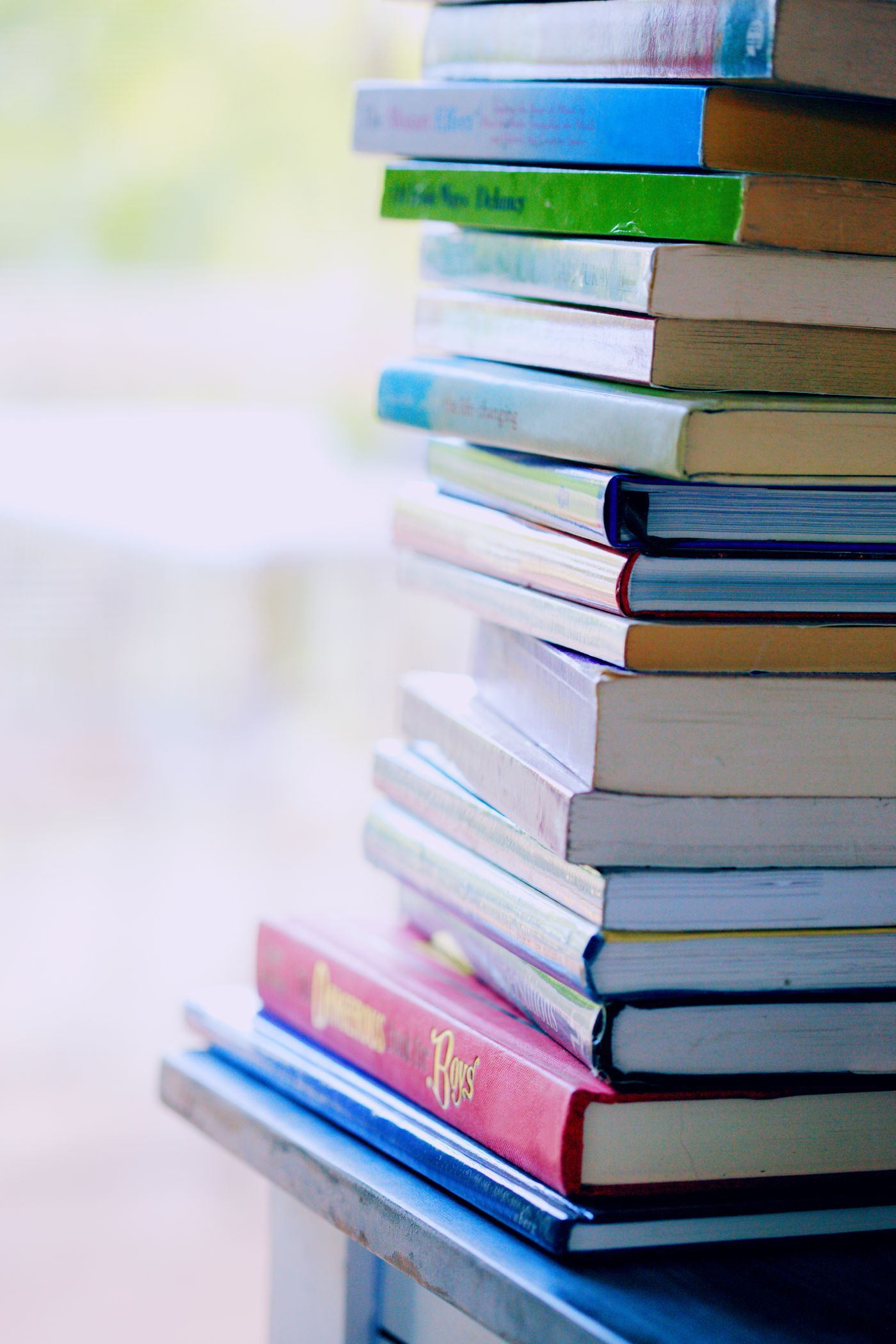 A stack of staff-pick books on a table