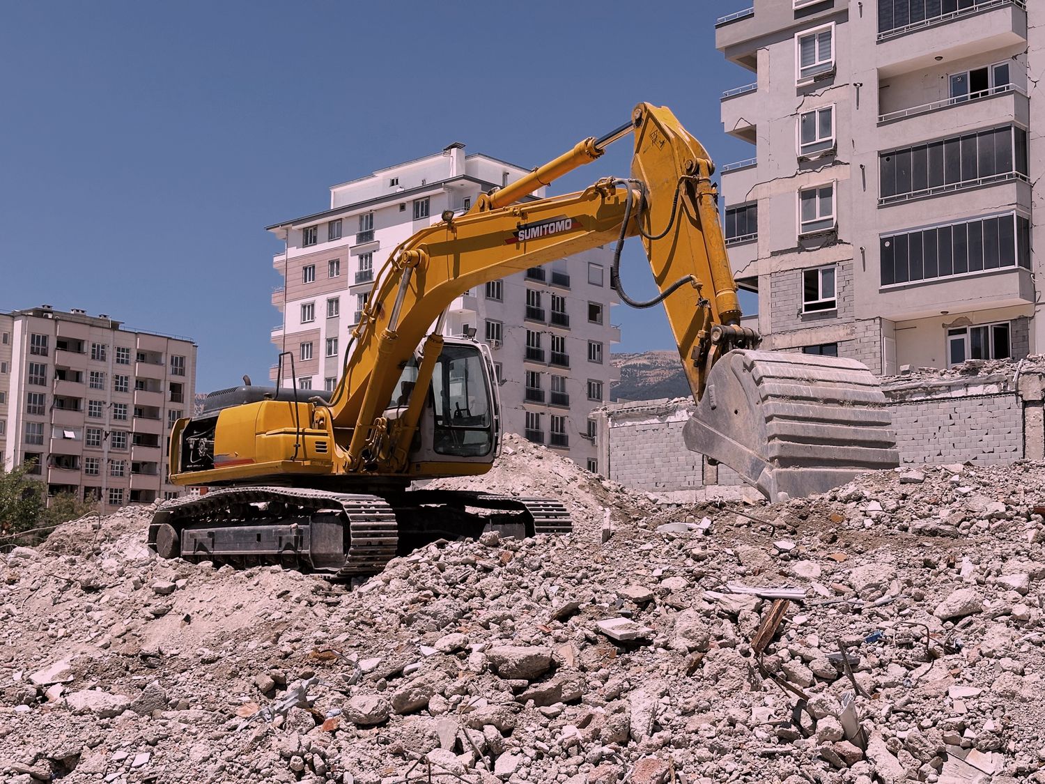 Excavator tearing into a building during demolition