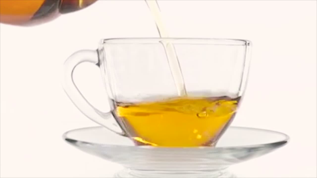 Loose-leaf tea being poured into a glass