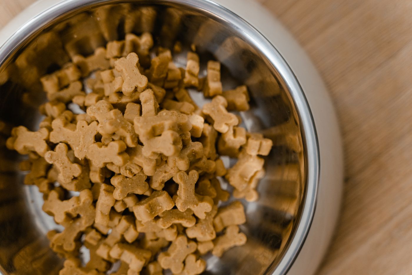 Bone-shaped biscuits in a stainless bowl