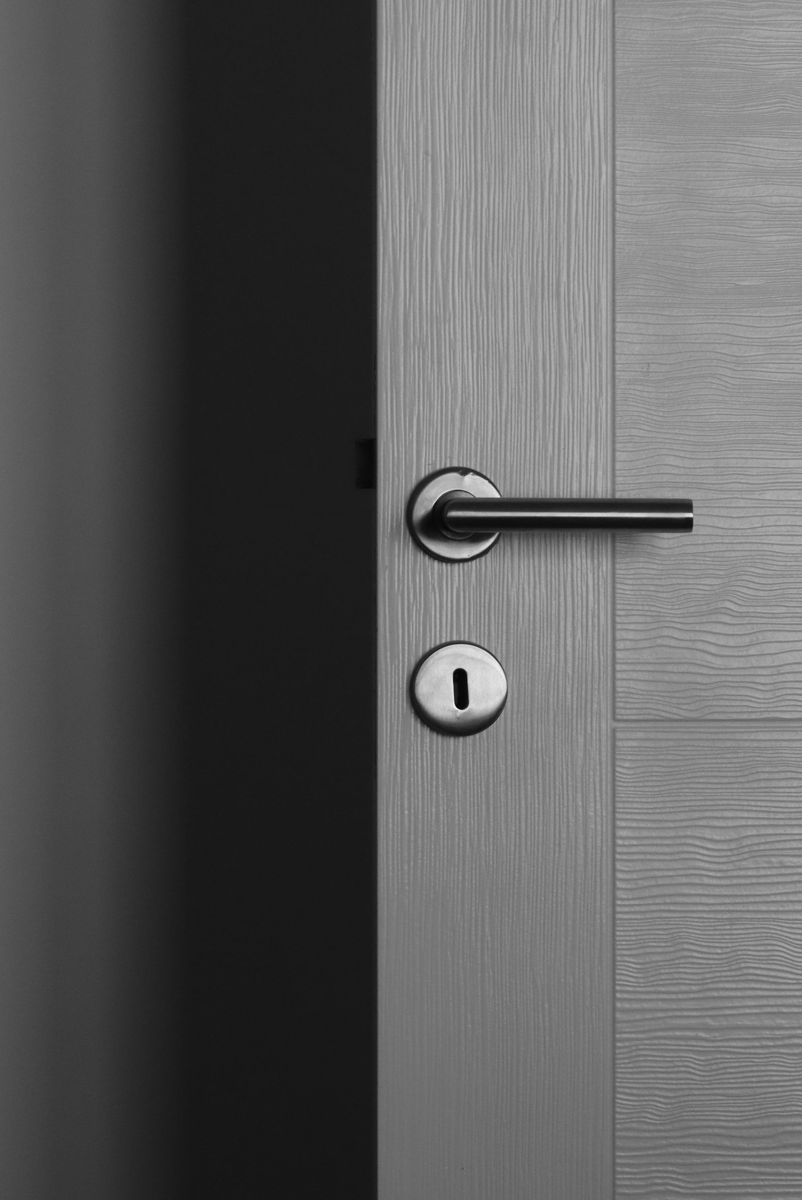 A modern grey lever with a lock cylinder