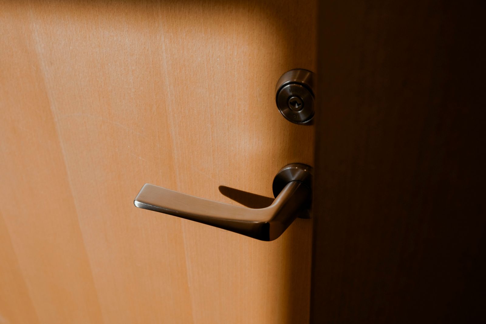A lever handle and lock cylinder on a door