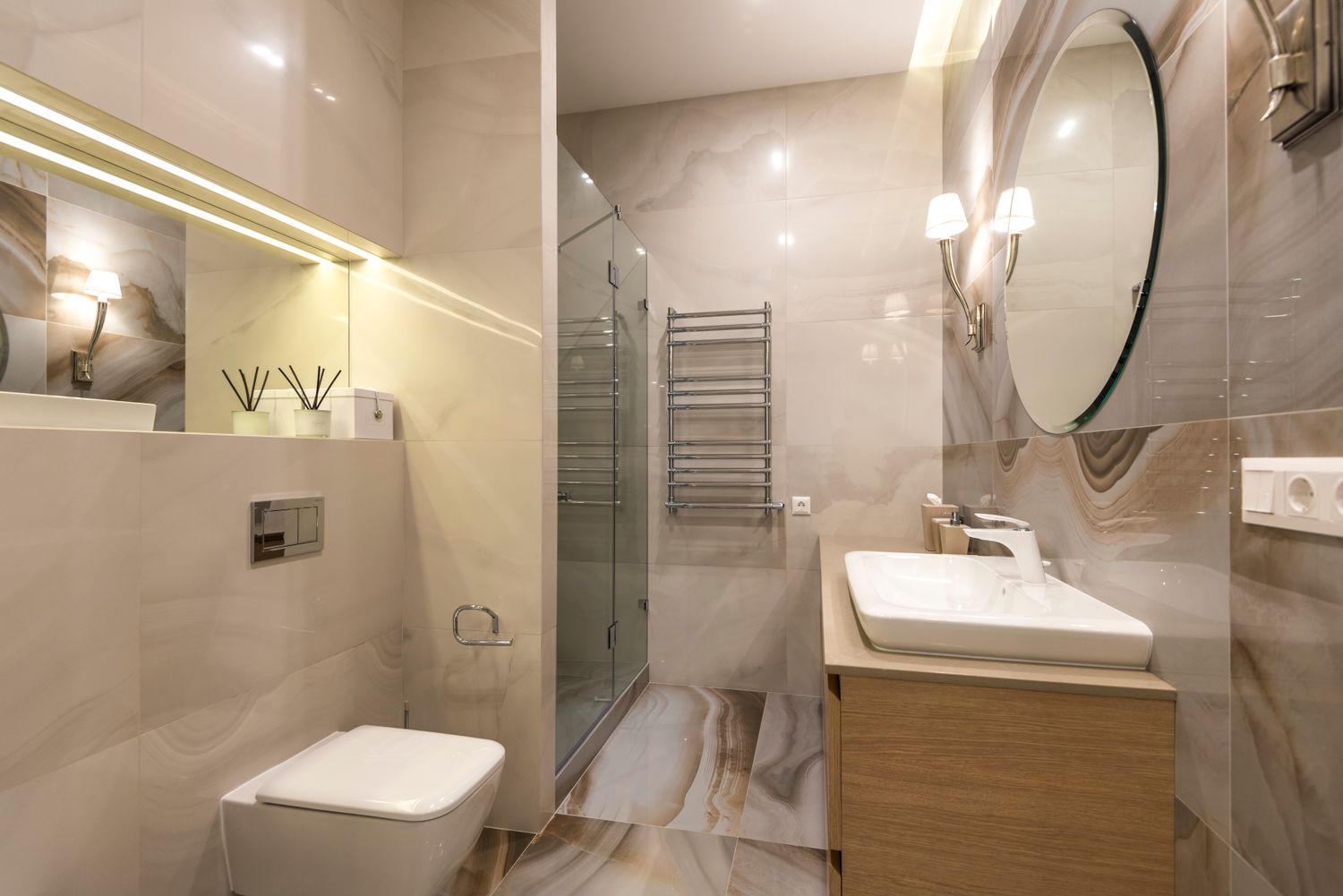 Clean finished bathroom with marble tile and modern fixtures